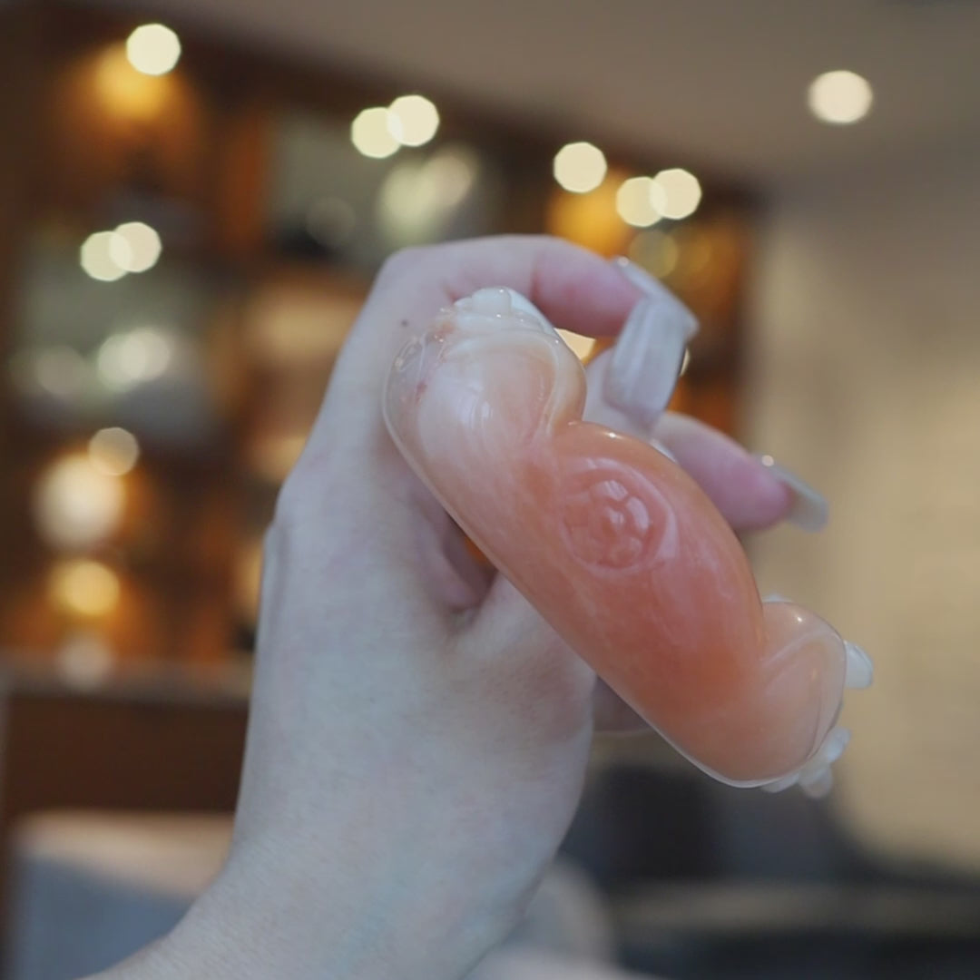 Pink-orange Mongolian jade bracelet featuring sculpted cat ears, floral carvings, and a small natural mark near one ear, highlighting its handcrafted charm – Miruzi