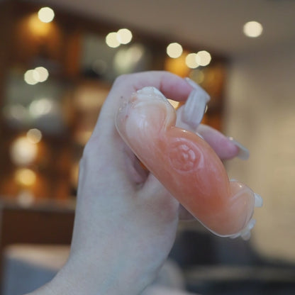 Pink-orange Mongolian jade bracelet featuring sculpted cat ears, floral carvings, and a small natural mark near one ear, highlighting its handcrafted charm – Miruzi
