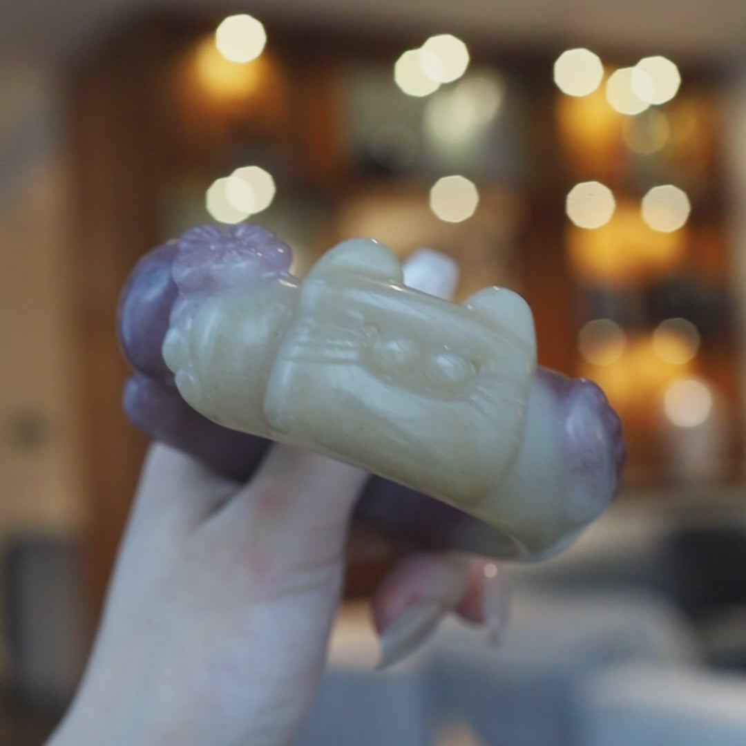 Wide Mongolian jade bracelet showcasing a cat face on one side and paws and tail on the other, blending motion and whimsy in stone – Miruzi