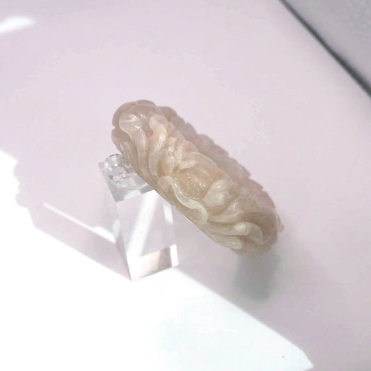 Translucent blush jade bracelet with detailed peony design, feminine and nature-inspired jewelry piece


