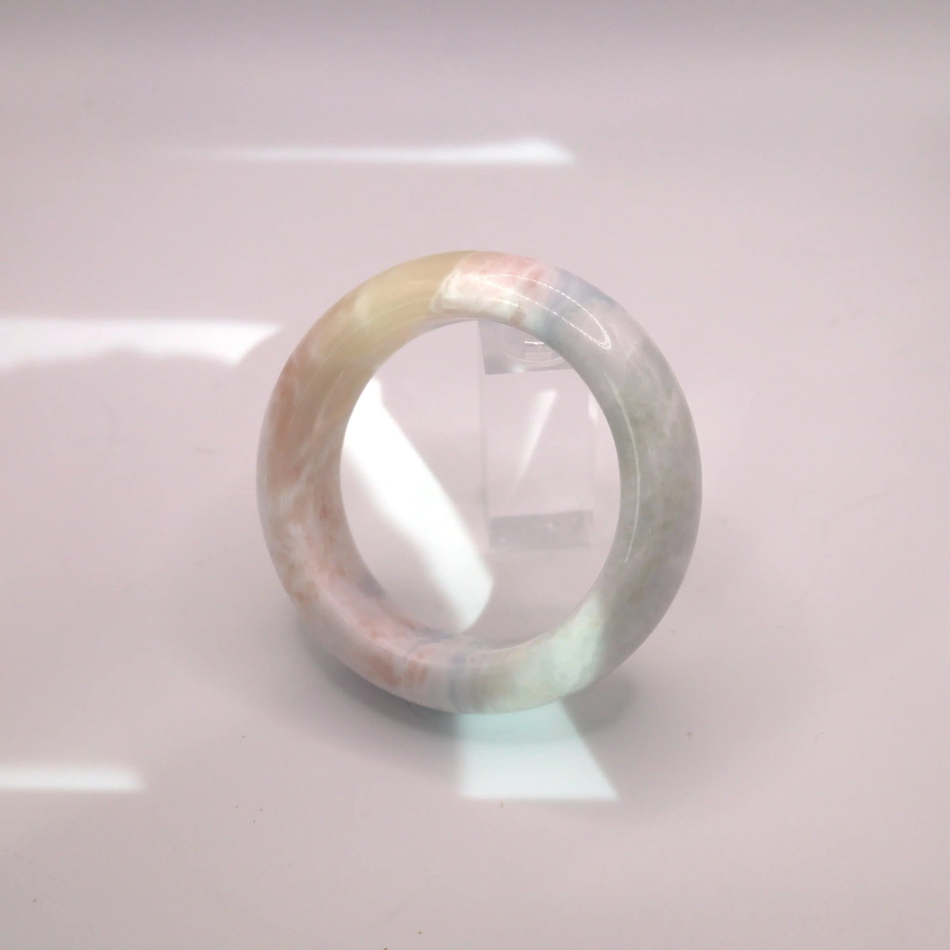 Natural Mongolian jade bracelet in rare light blue with organic pastel gradients and soft polish

