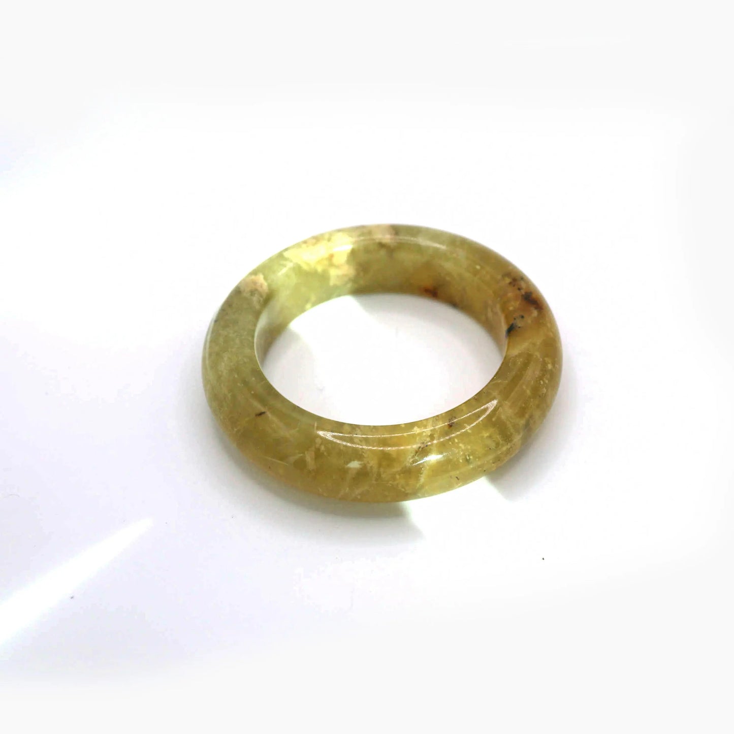 Translucent golden jade bangle with organic yellow-white veining and smooth rounded structure

