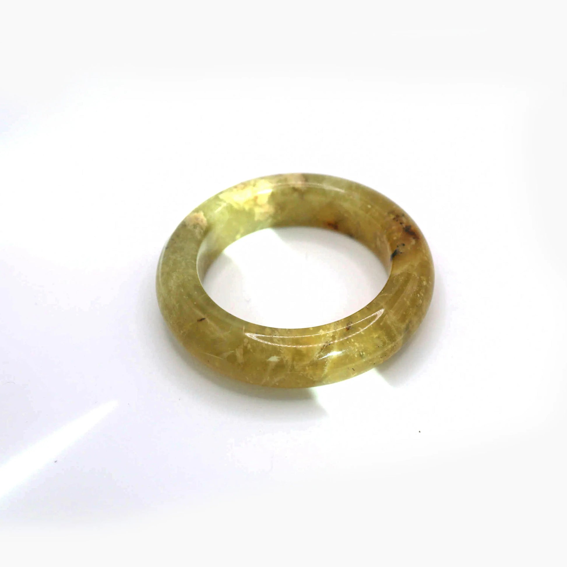 Translucent golden jade bangle with organic yellow-white veining and smooth rounded structure

